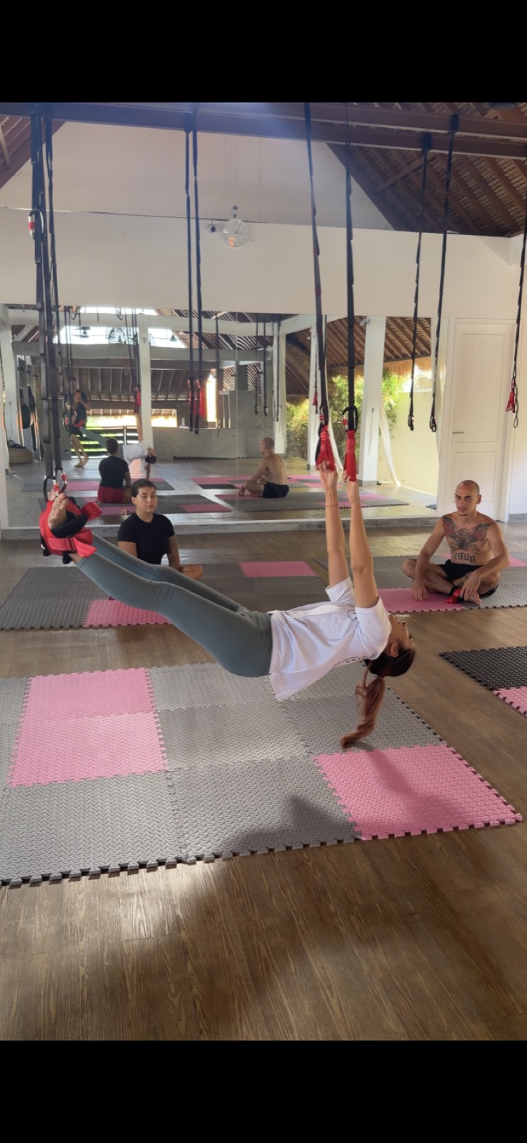 Guest in a supported hang on the lianas during class